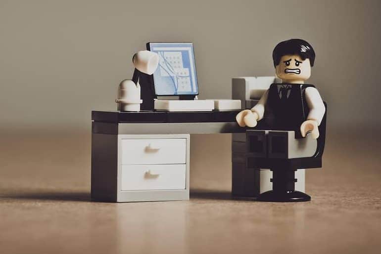 Image of a lego character with a frustrated face. He is sitting at a computer (as if he is participating in a game jam).